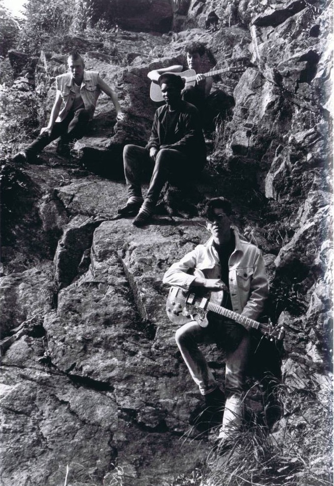 A group of people on a rock

Description automatically generated