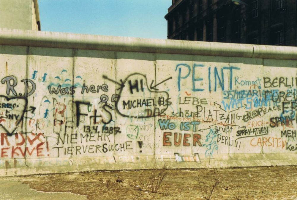 A graffiti covered building

Description automatically generated
