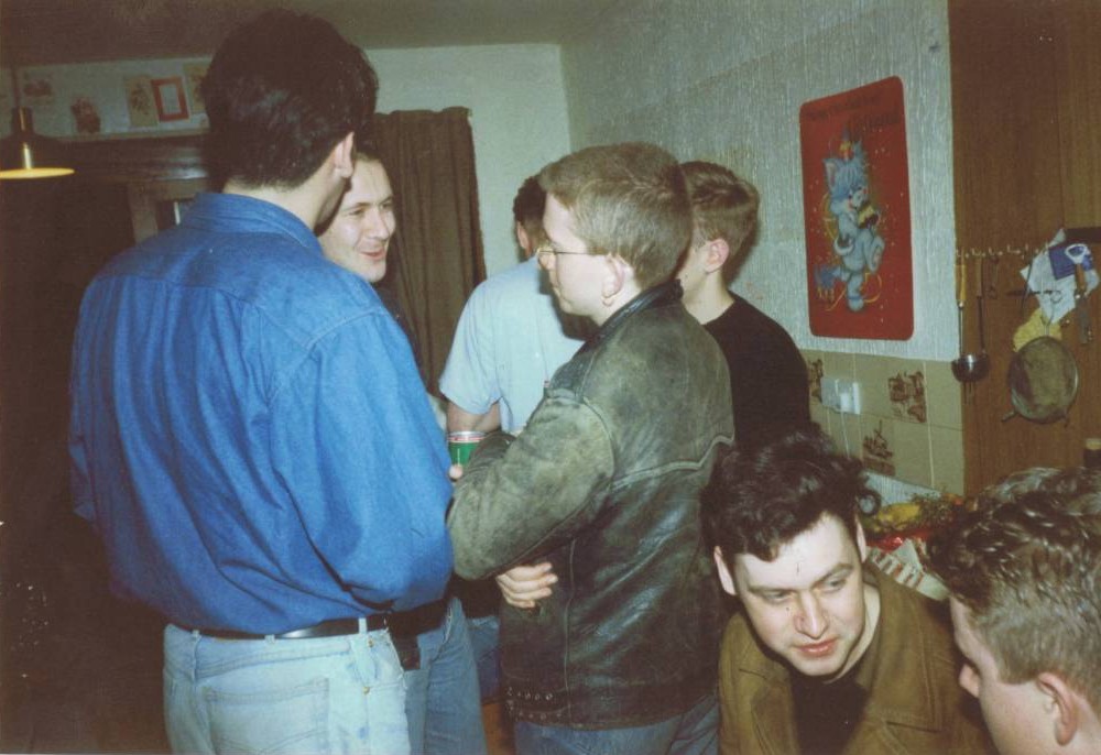 A group of people standing in a room

Description automatically generated