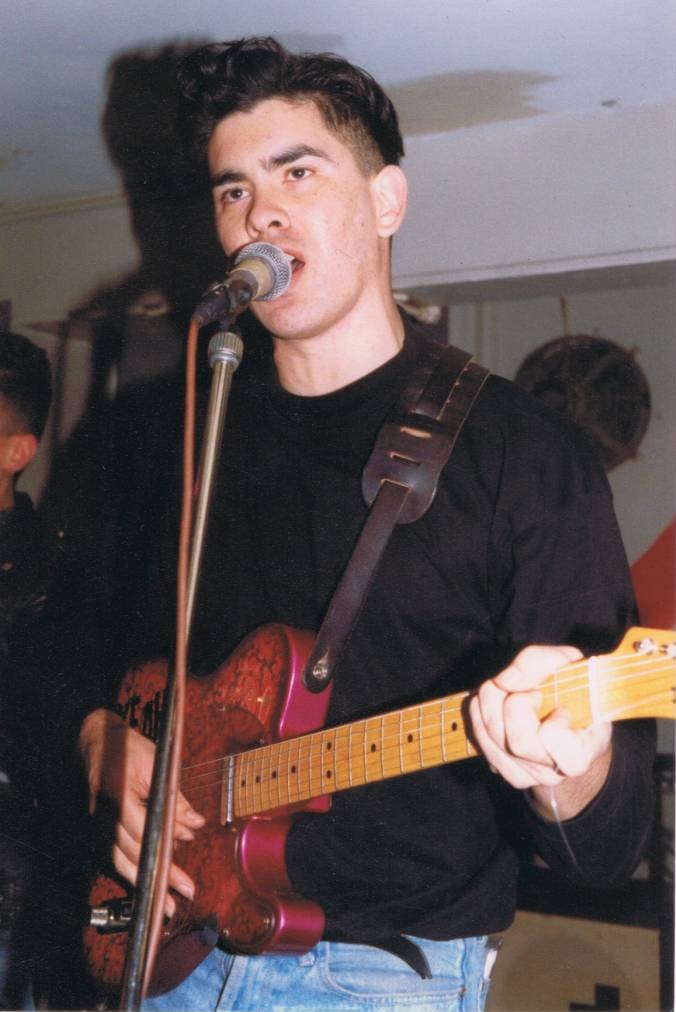 A person holding a guitar

Description automatically generated
